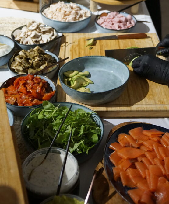 Bagels station buffet with summer decor and assorted toppings at Taste Corner’s catered event in South Florida