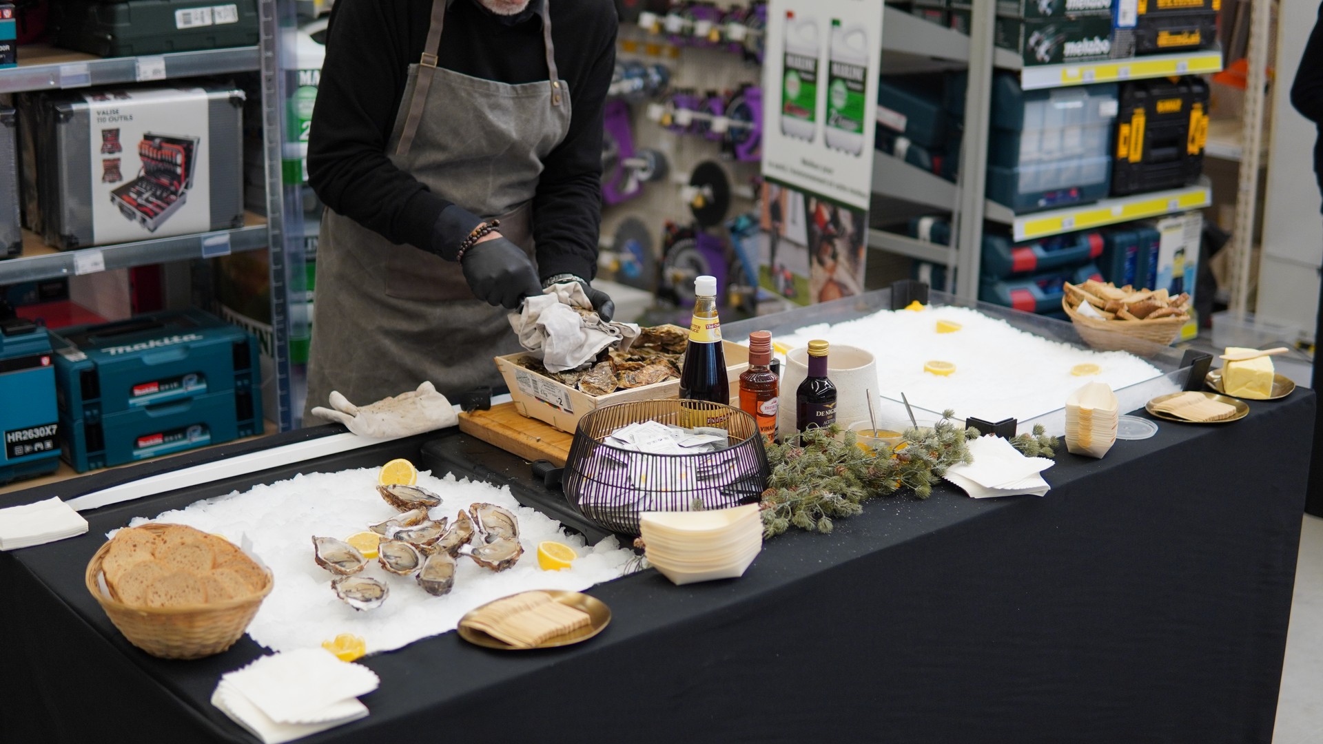 Chef preparing fresh oysters at Taste Corner’s oyster station during a catered event in South Florida