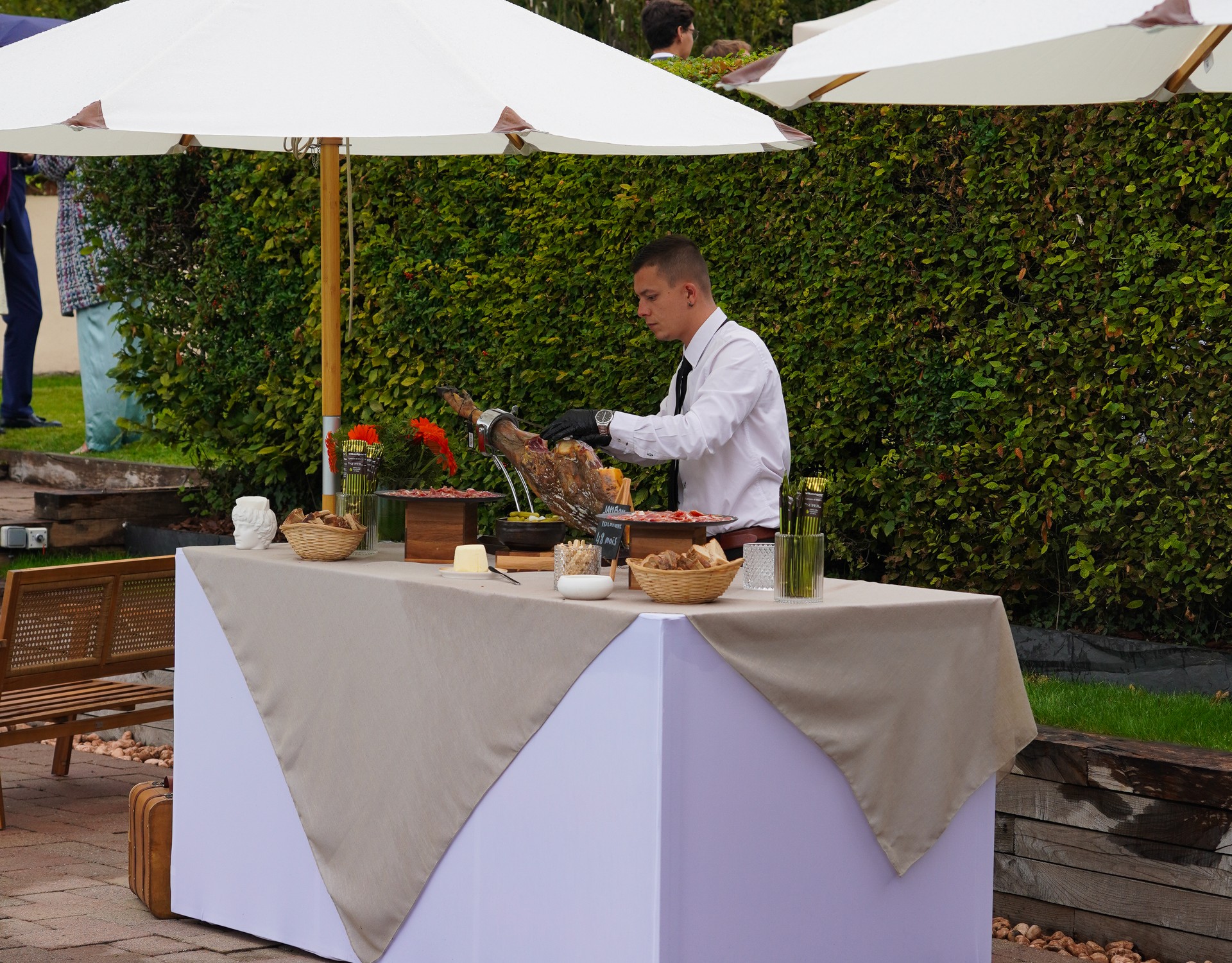 Chef carving premium ham at Taste Corner’s elegant rooftop station during a corporate event in South Florida