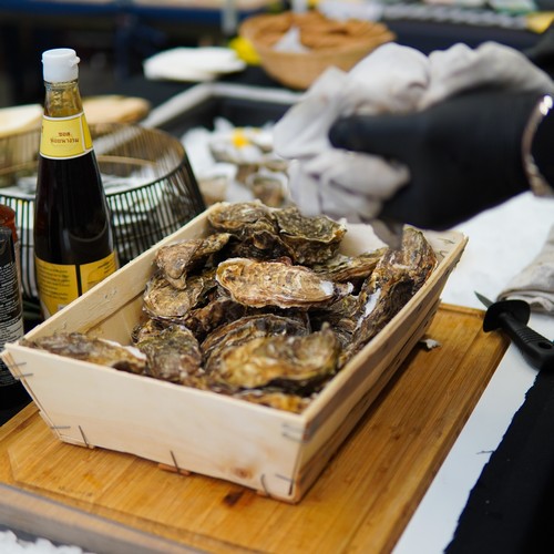 Chef preparing fresh oysters at Taste Corner’s oyster station during a catered event in South Florida