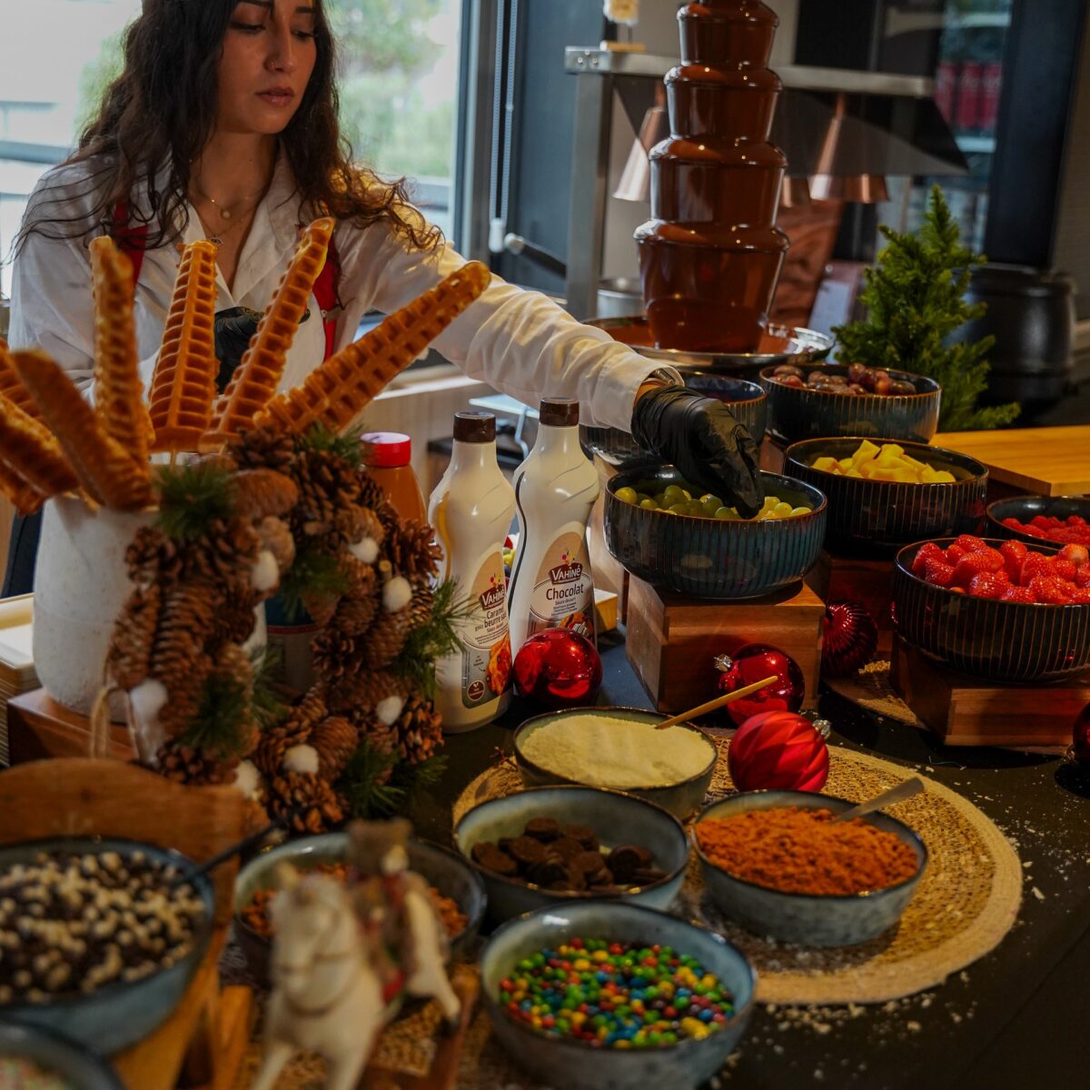 Chocolate fountain live station with chef preparing fresh fruit at Taste Corner event catering