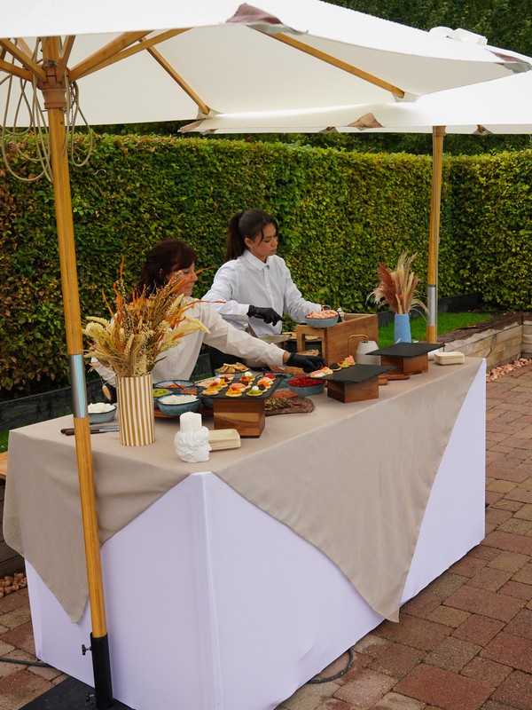 Taste Corner blinis live station with two chefs preparing blinis at an event in South Florida