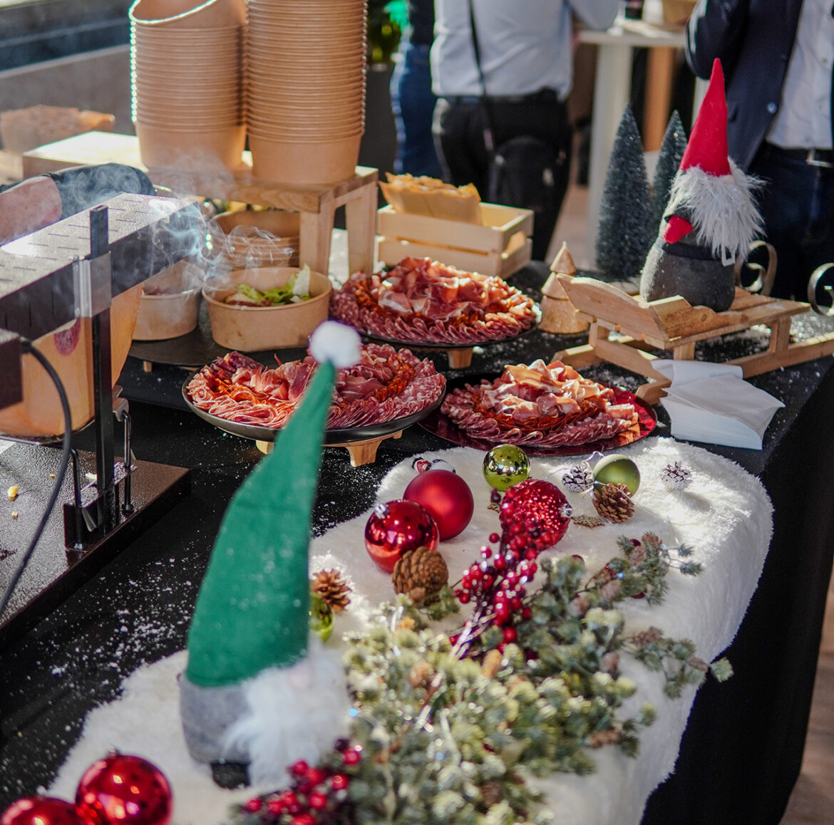 raclette-station-christmas-event-cheese-catering-miami Raclette station with melted cheese and festive decor at Taste Corner’s Christmas event in South Florida