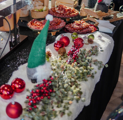 Raclette station with melted cheese and festive decor at Taste Corner’s Christmas event in South Florida