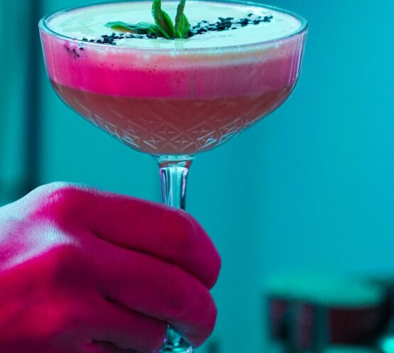 Bartender handing an elegant cocktail at Taste Corner’s catered event in South Florida