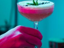 Bartender handing an elegant cocktail at Taste Corner’s catered event in South Florida
