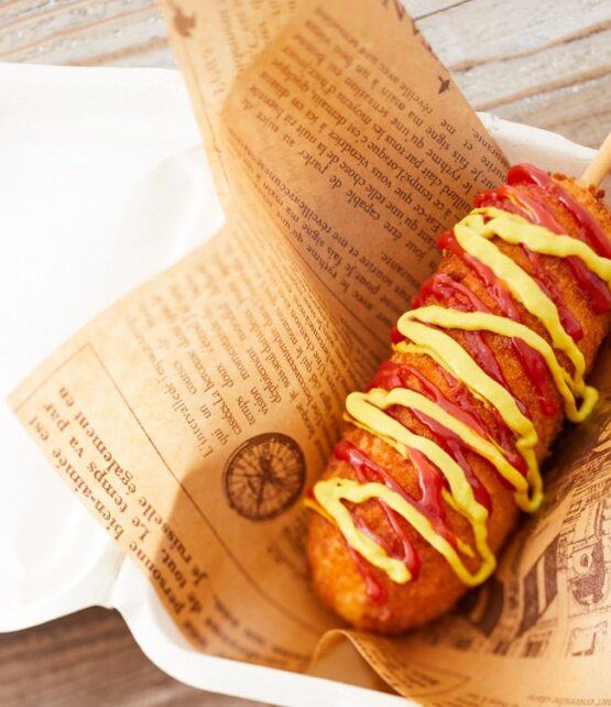 Freshly prepared corn dog ready to be enjoyed at Taste Corner’s catering station during an event