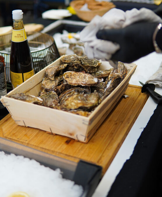 Chef preparing fresh oysters at Taste Corner’s oyster station during a catered event in South Florida