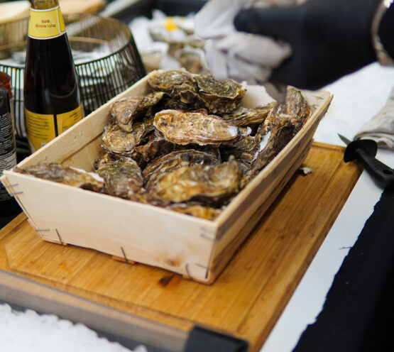 Chef preparing fresh oysters at Taste Corner’s oyster station during a catered event in South Florida