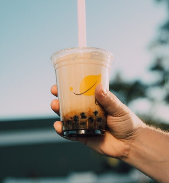 Person holding a bubble tea at Taste Corner’s event with toppings drink station in South Florida