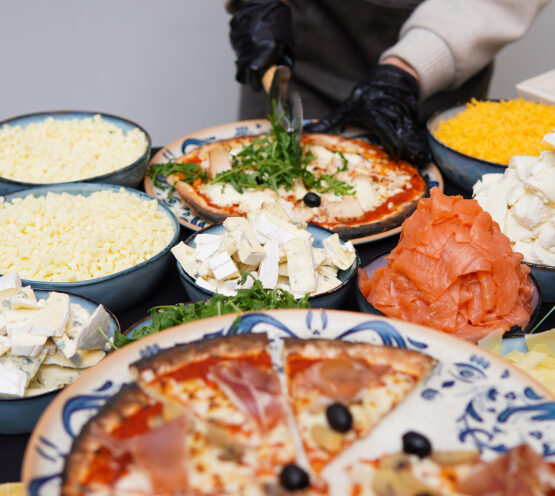 Chef preparing artisanal pizza at Taste Corner’s scenographic pizza station during an event in South Florida