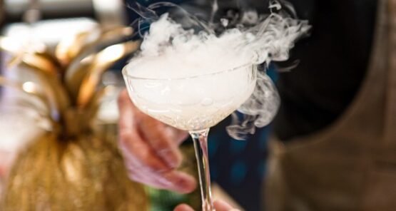 Barman serving a smoking cocktail to a guest at Taste Corner’s event