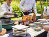 Chefs preparing crêpes with assorted toppings and syrups at Taste Corner’s live station during a catered event in South Florida