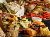 Spring grazing table with charcuterie, cheeses, fruits, cakes, and seeds at Taste Corner’s catered event in South Florida