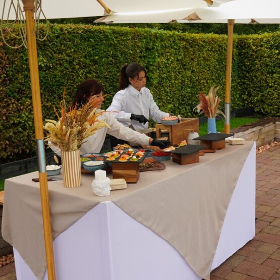 Taste Corner blinis live station with two chefs preparing blinis at an event in South Florida