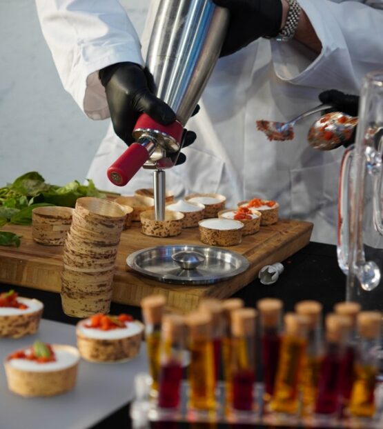 Chef preparing burrata live station at Taste Corner event catering in South Florida