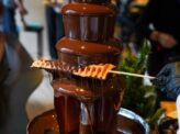 Chocolate fountain live station with chef preparing fresh fruit at Taste Corner event catering