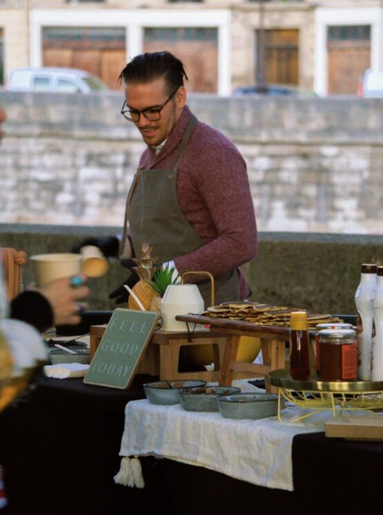 pancakes-live-station-chef-toppings-event-catering-miami Chef preparing pancakes at Taste Corner’s live station with toppings for event catering in South Florida