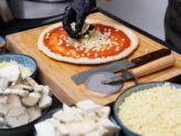 Chef preparing artisanal pizza at Taste Corner’s scenographic pizza station during an event in South Florida