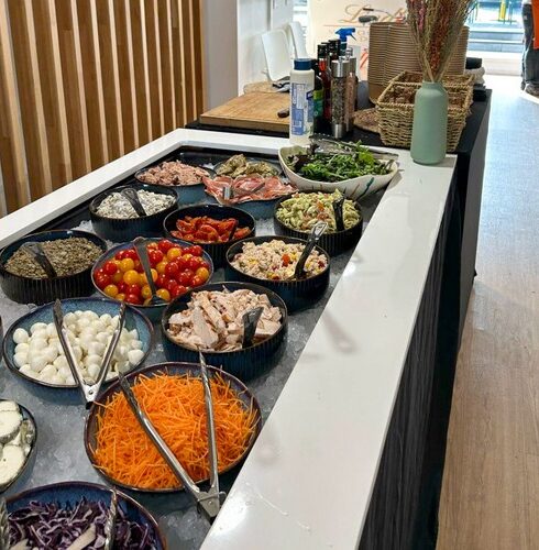 Salad station with assorted toppings and dressings at Taste Corner’s catered event in South Florida