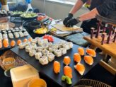 Chef preparing sushi at Taste Corner’s Japanese-style buffet during a catered event in South Florida