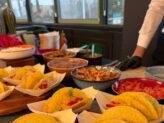 Chef preparing gourmet tacos at Taste Corner’s scenographic station during a catered event in South Florida